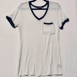 POL, size medium. White/ gray trim. Short sleeve. Front pocket is frayed.